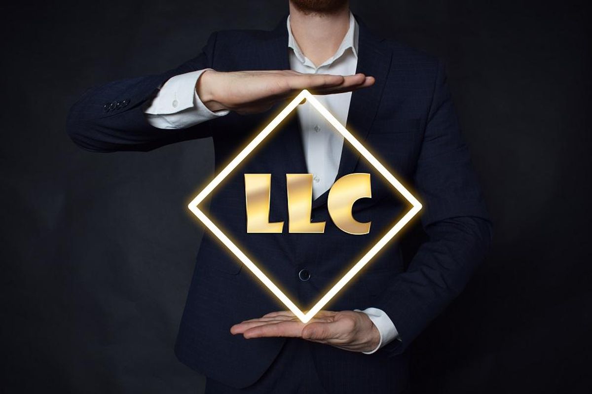 A businessman shows an inscription:LLC