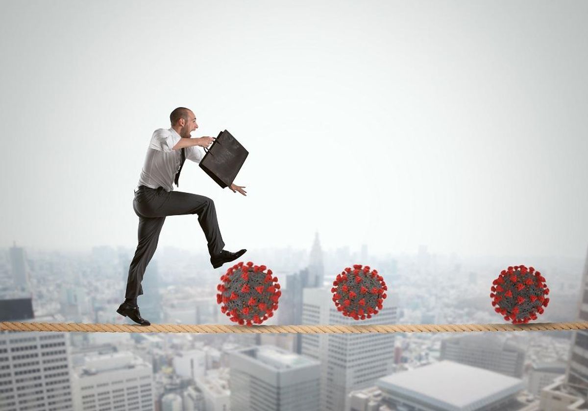 Business man hops to dodge the viruses