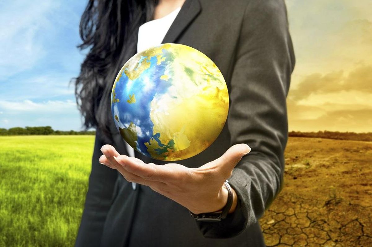 Business woman holding the earth