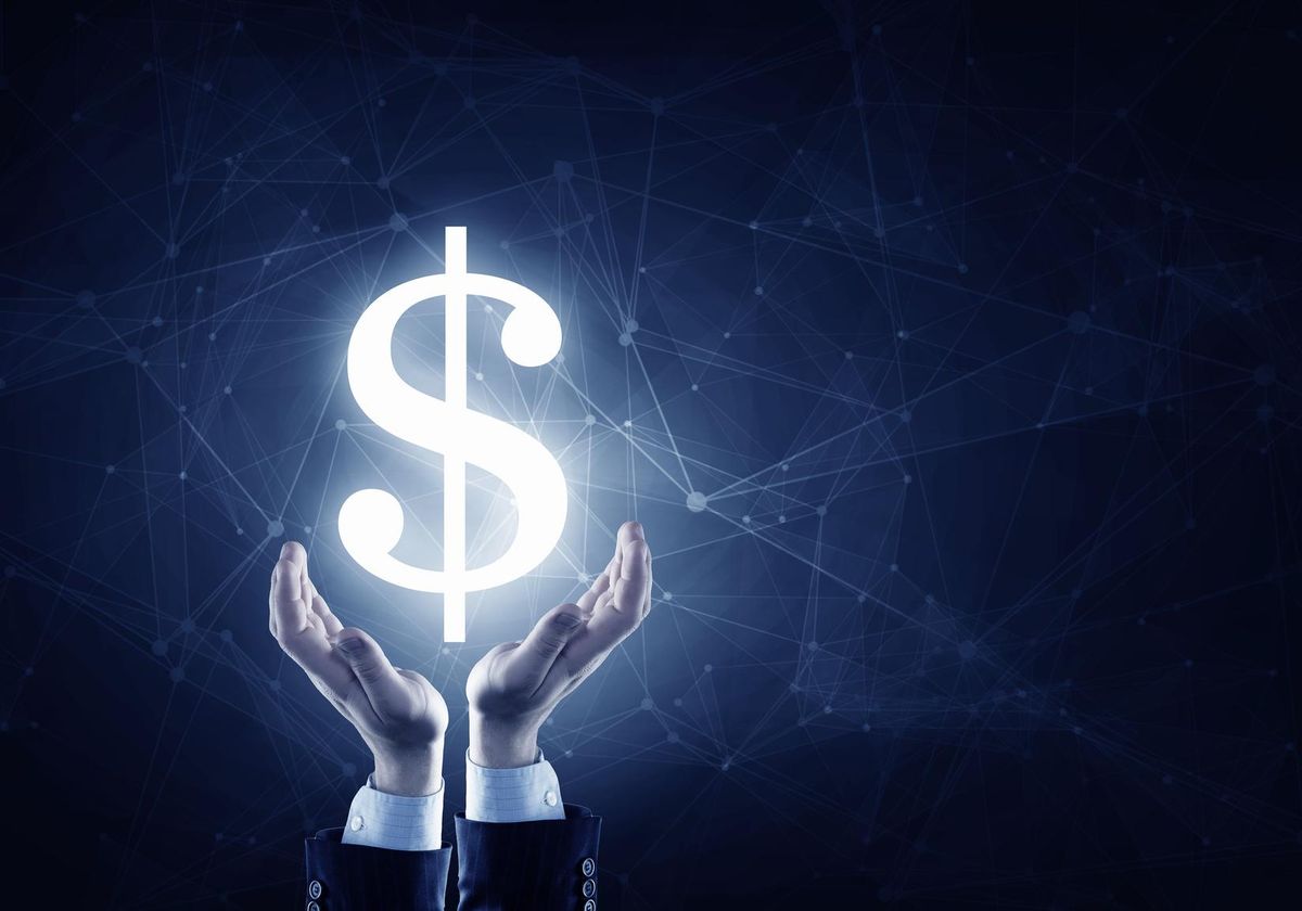 Businessman hands holding glowing dollar sign
