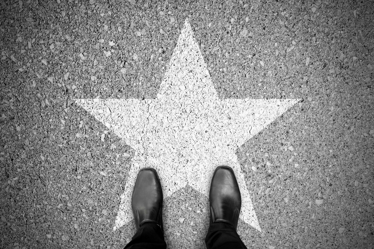 Businessman in search of investors looking at a celebrity star