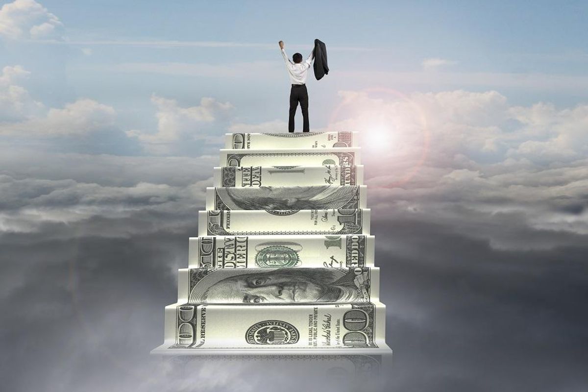 businessman on top of money stairs