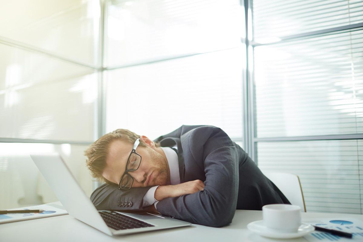 Businessman sleeping at his workplace