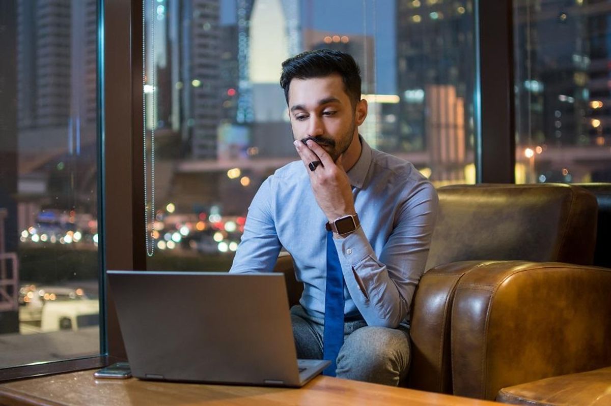 Businessman using laptop to read his business's financial statements