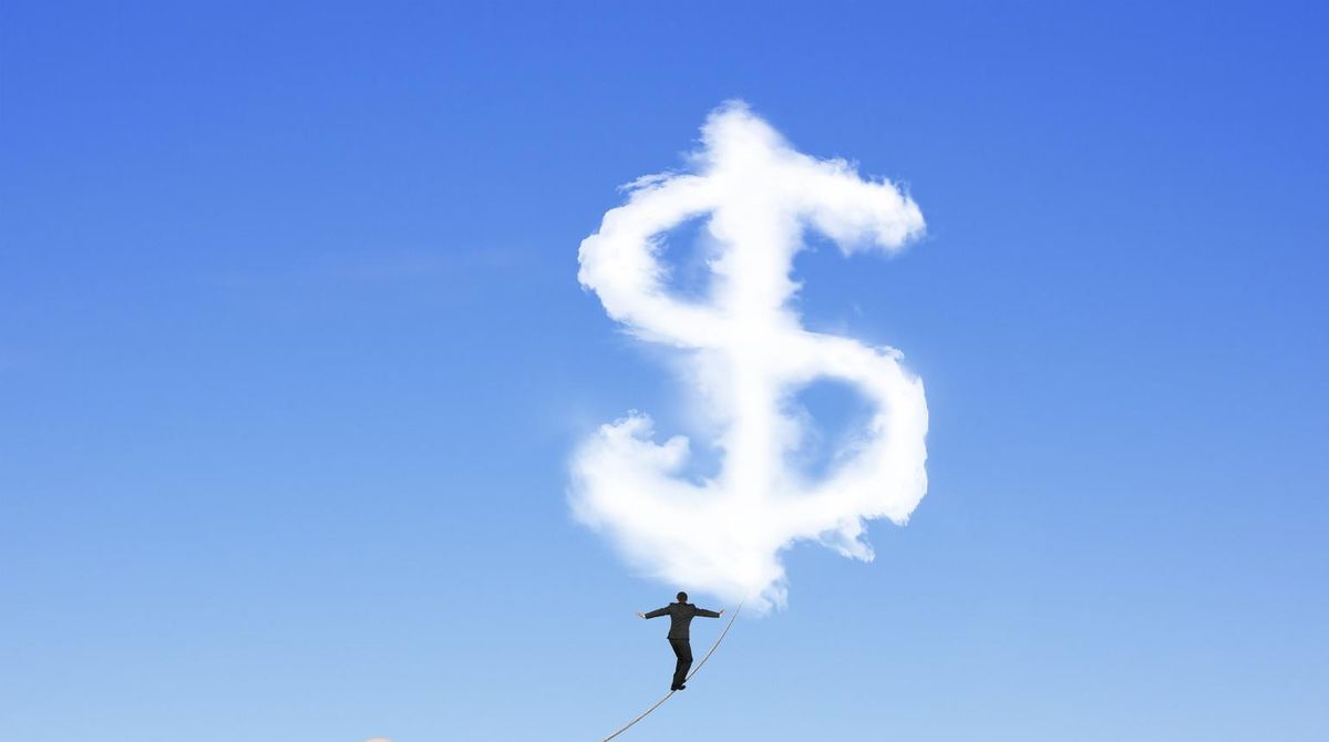 Businessman walking tightrope