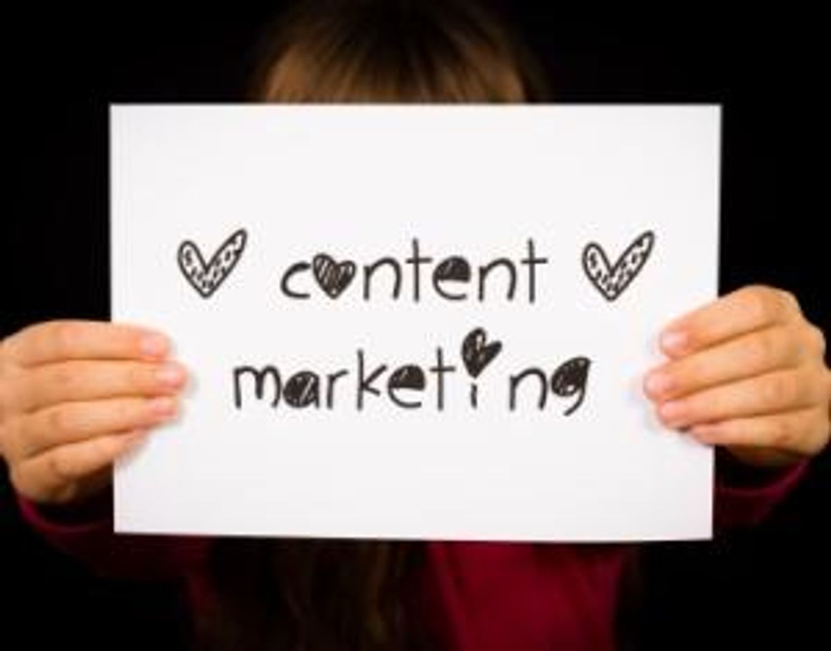 Child holding Content Marketing sign