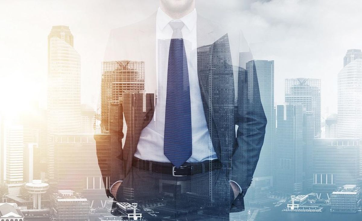 close up of businessman over city buildings