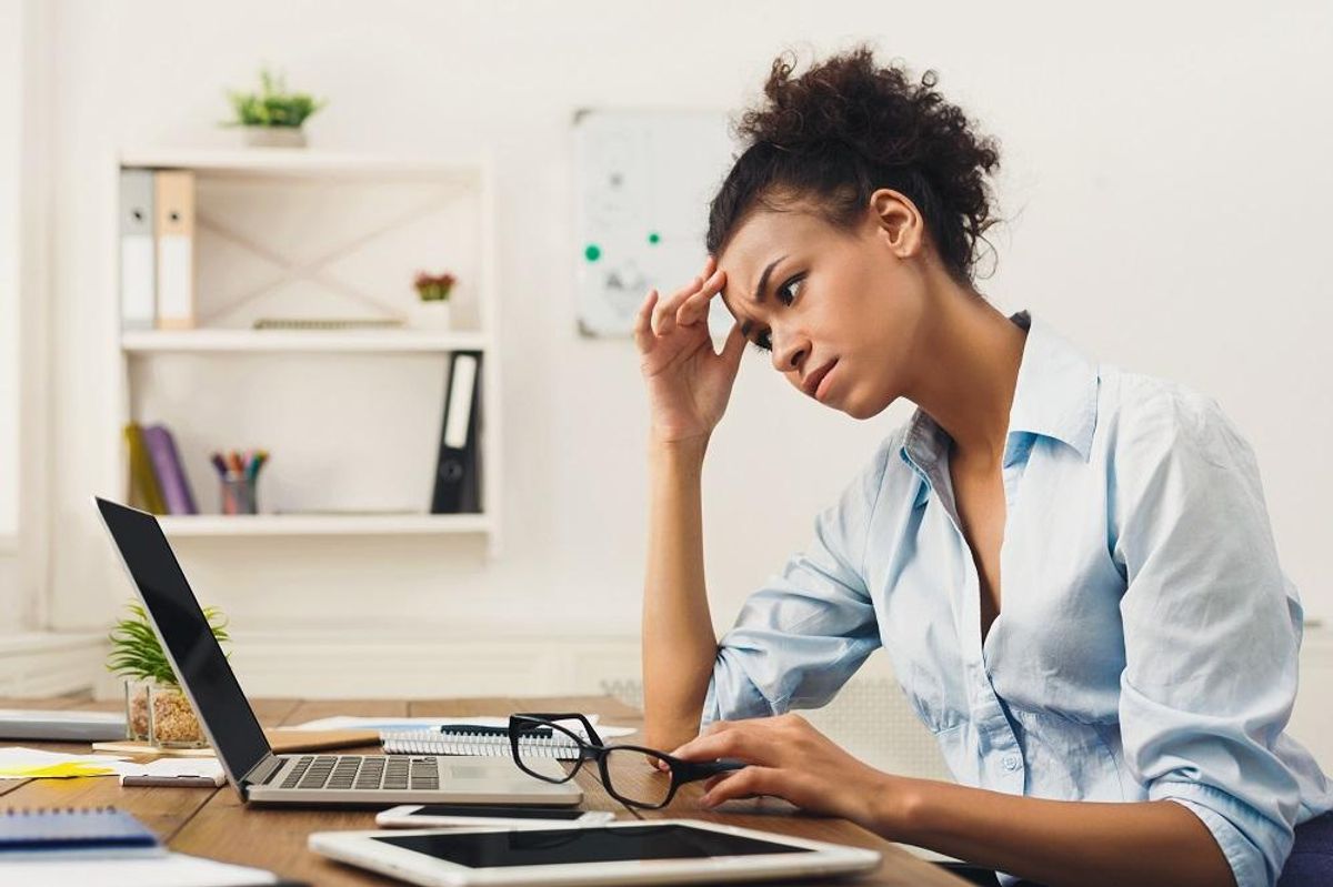 Frustrated small business owner realizing she needs to hire an expert