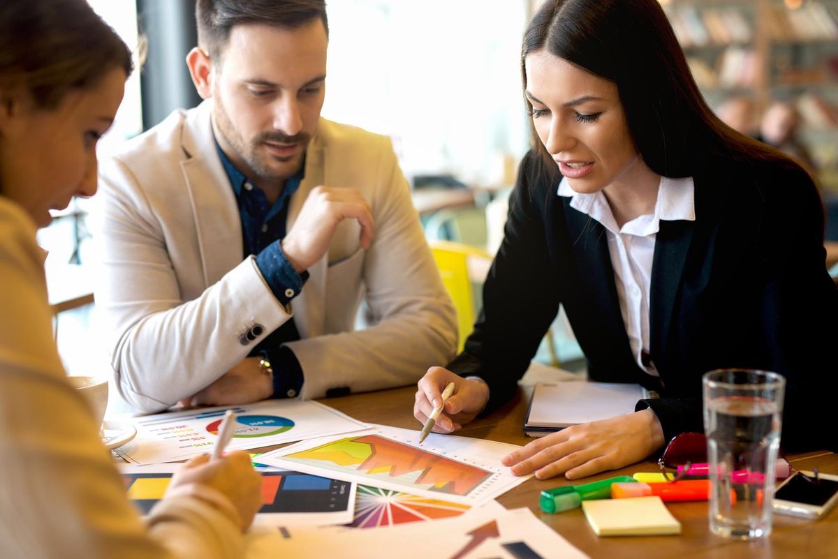 Group of business people brainstorming business challenges.