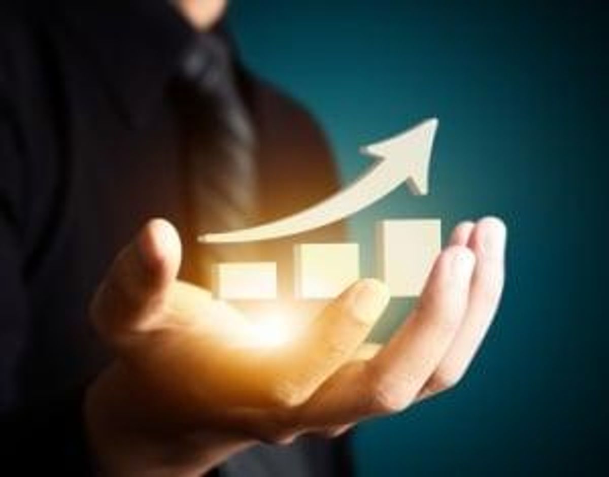 Hand holding a rising arrow