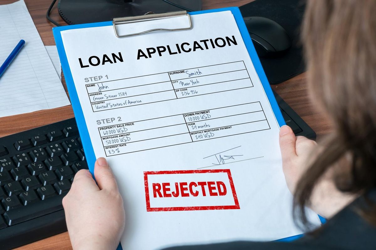Loan application form with rejected stamp.