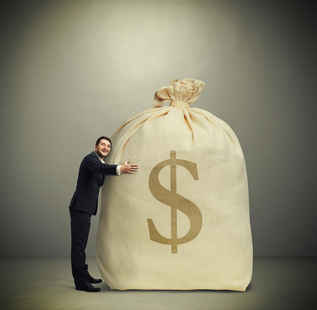 man embracing big bag with money