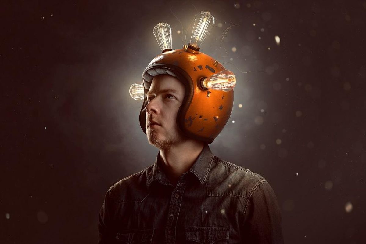 man with light bulb helmet