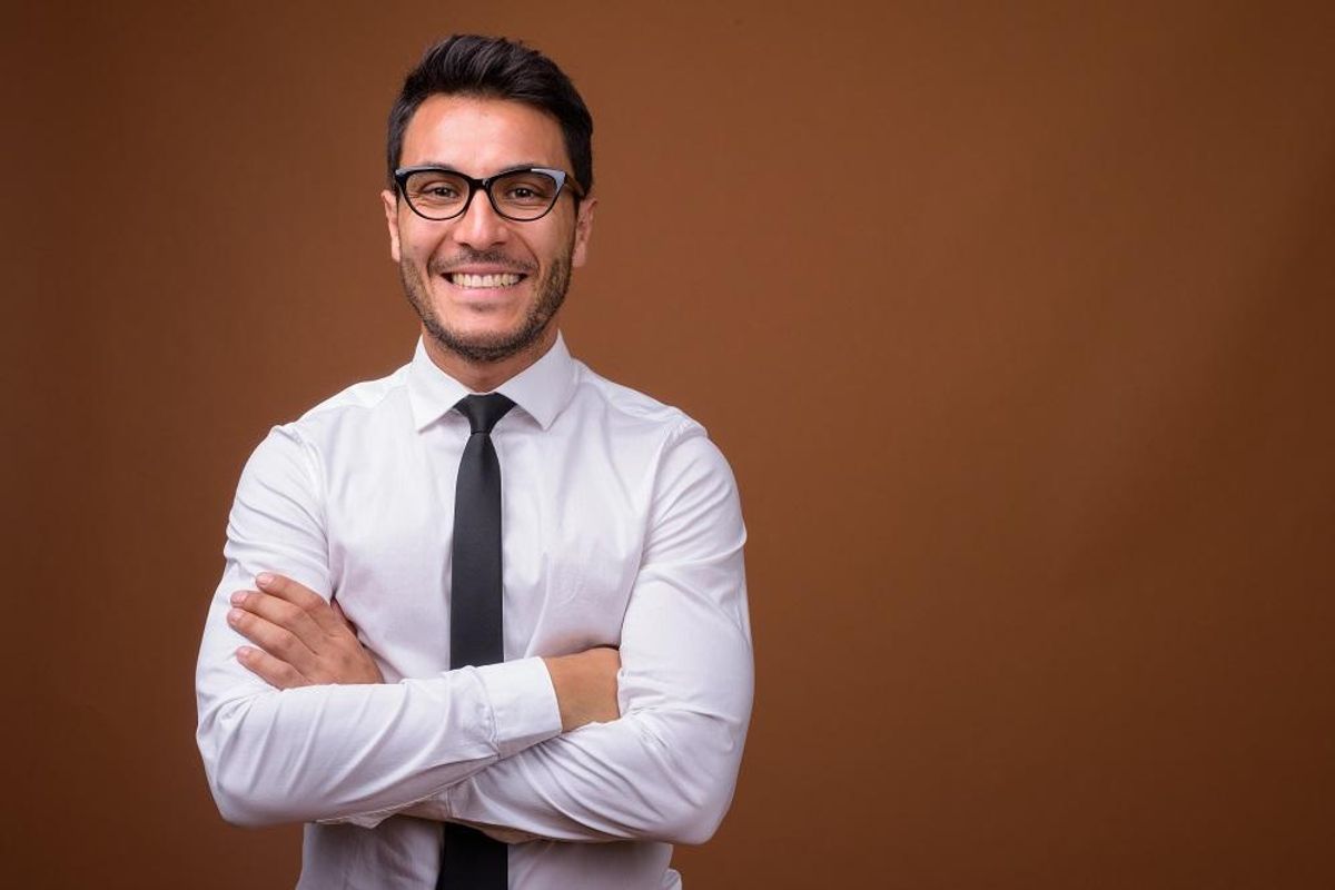 shot of young handsome Hispanic businessman