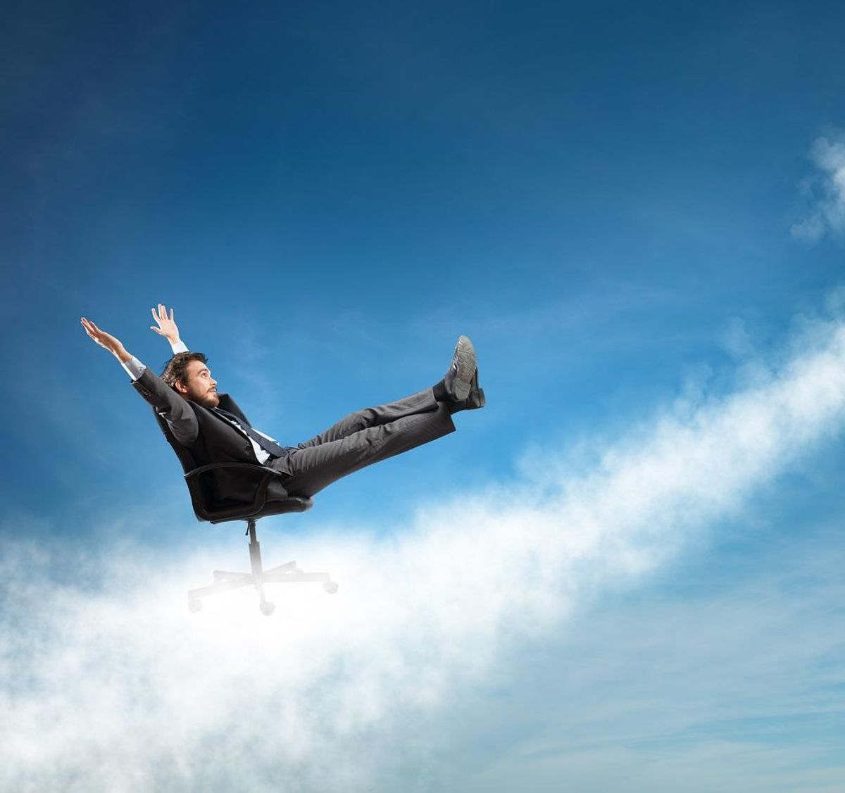 Successful businessman over a cloud like an arrow
