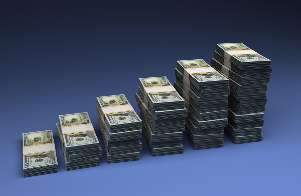 The growth of money, stacked on top of each other, representing why you should invest.