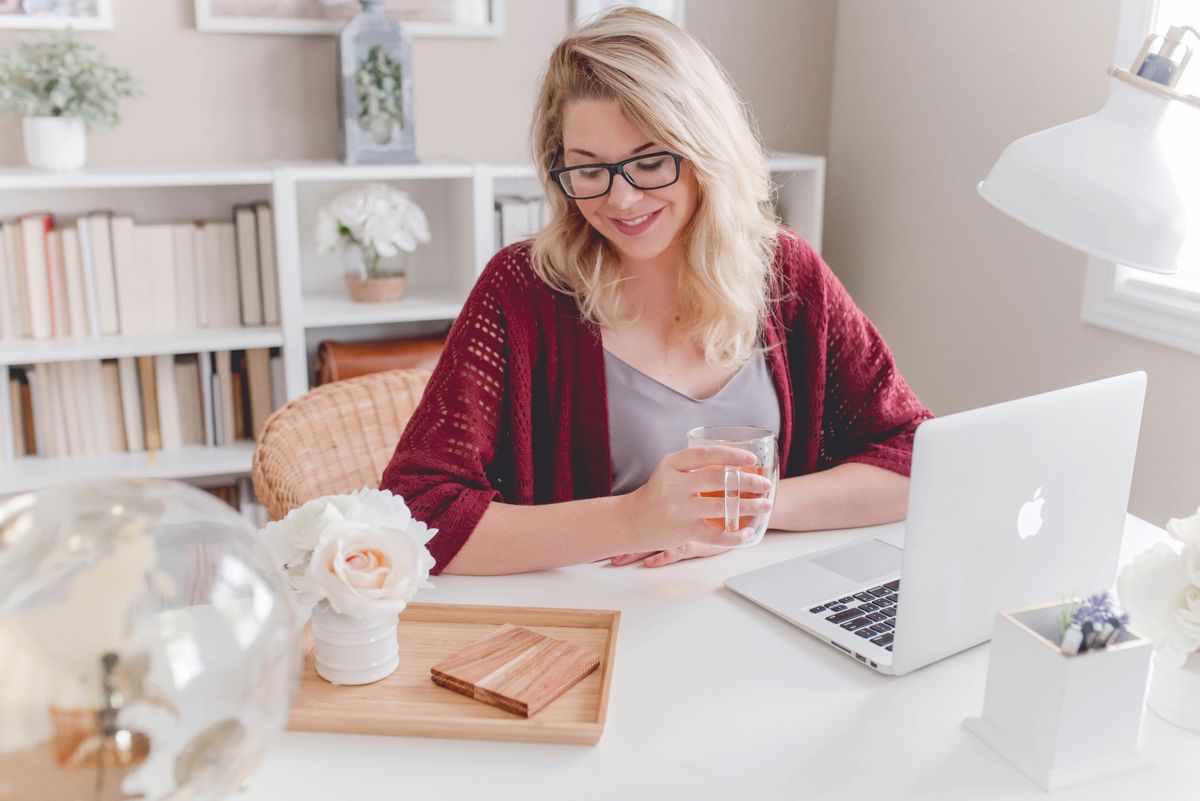 Woman in a pretty, bright home office space