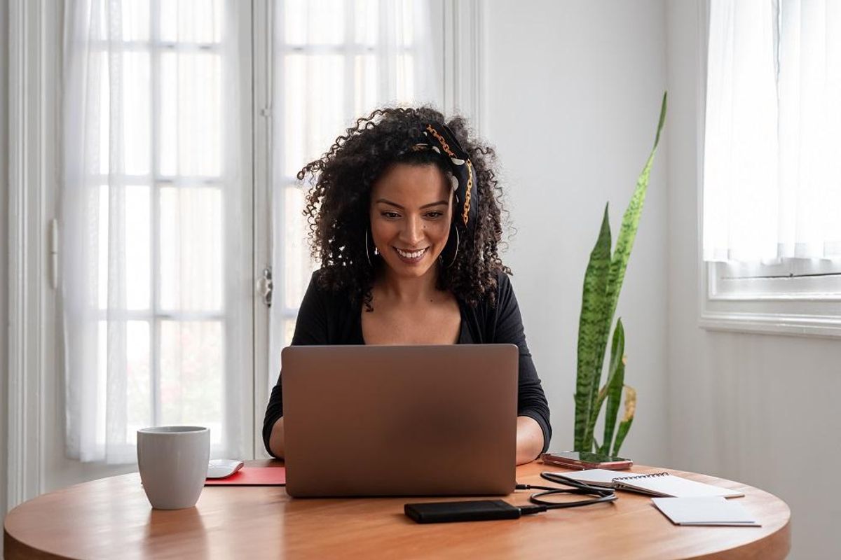 Woman reading the best business websites on her laptop