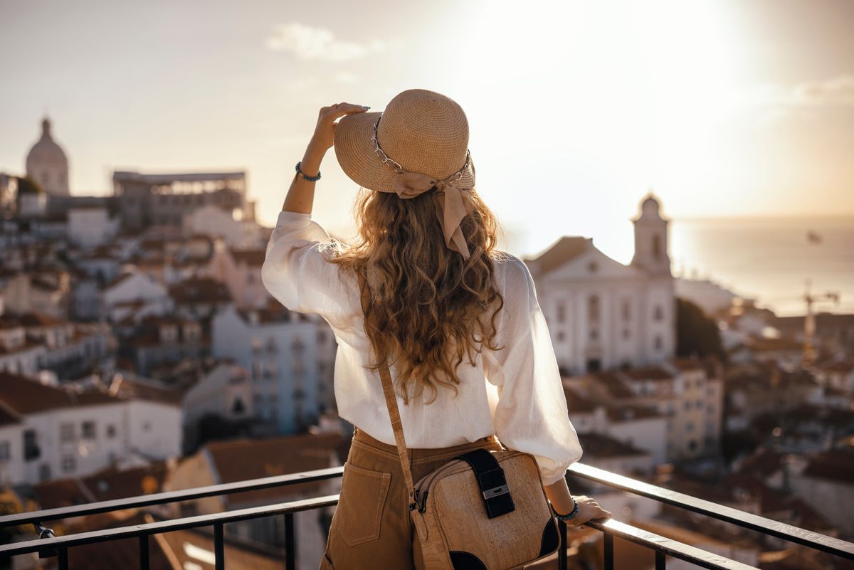 Woman standing on the balcony of an easy residency country