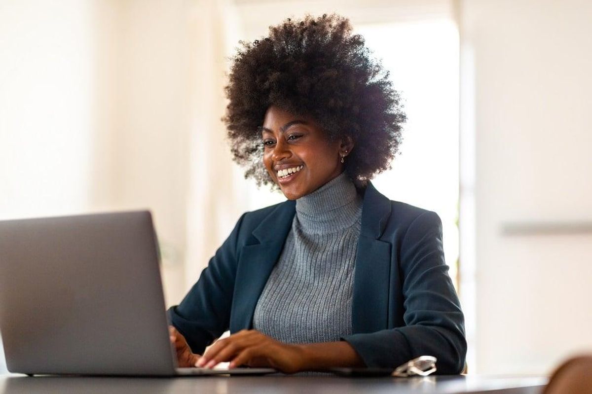 young businesswoman sitting in office smiling