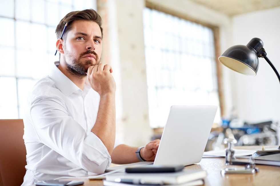 young man in home office thinking